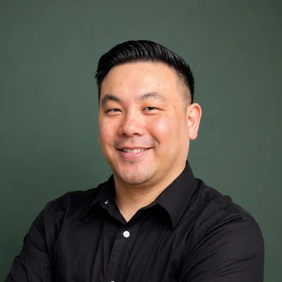 A headshot of Dr. Garrett Woo, a chiropractor at Resolve Chiropractic.